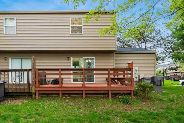 rear view of house with a yard and a deck