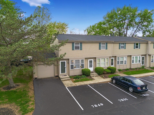 townhome / multi-family property with entry steps and uncovered parking