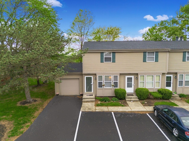 townhome / multi-family property with uncovered parking and entry steps