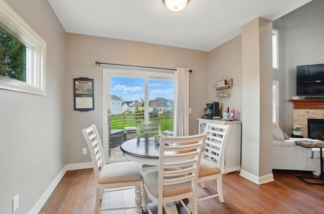 dining room with baseboards, wood finished floors, and a wealth of natural light