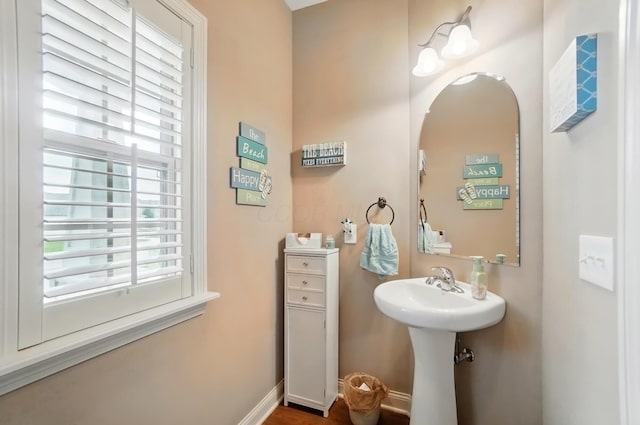 bathroom with baseboards and a sink