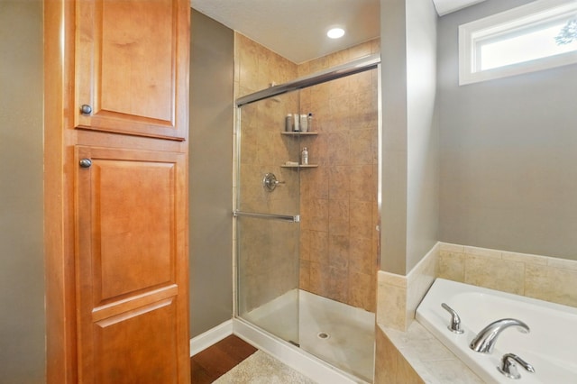 full bath featuring recessed lighting, baseboards, a shower stall, and a bath