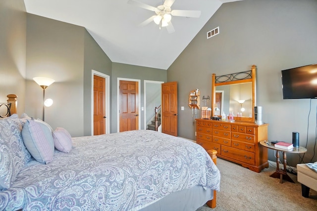 carpeted bedroom featuring a ceiling fan, high vaulted ceiling, and visible vents