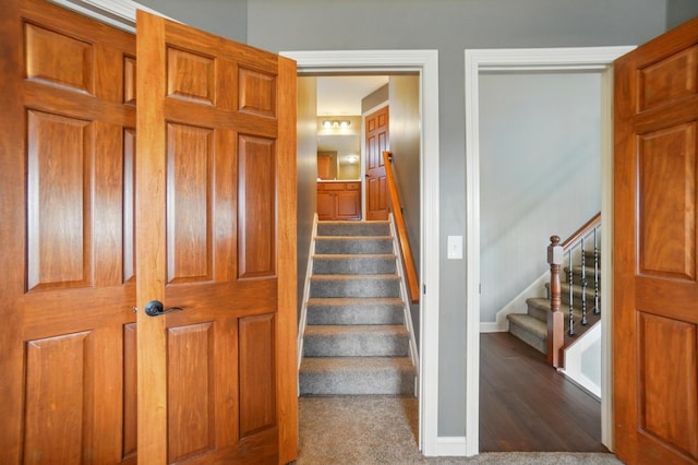 stairway with baseboards and wood finished floors