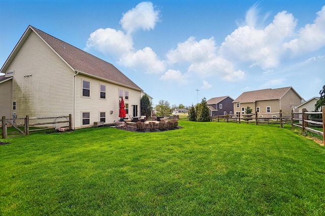 back of property with a yard, a fenced backyard, and a patio area