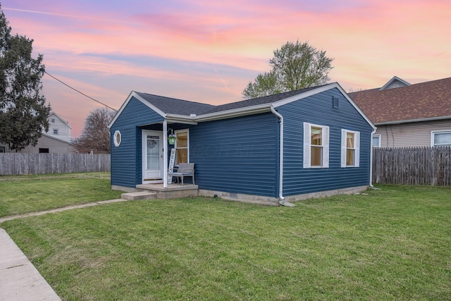 ranch-style house with fence and a front yard