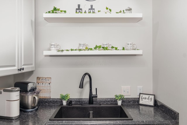 details featuring open shelves, a sink, and white cabinetry