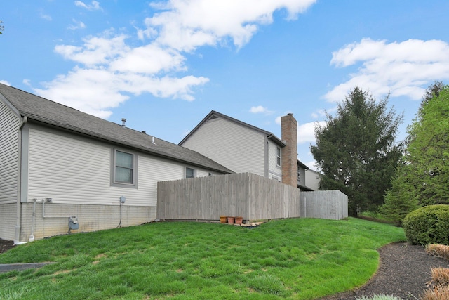 exterior space featuring fence and a yard