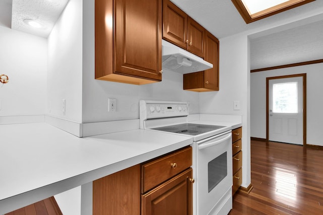 kitchen with a textured ceiling, light countertops, electric stove, under cabinet range hood, and dark wood-type flooring
