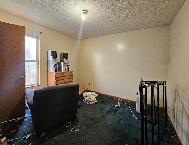 carpeted home office featuring baseboards and a textured ceiling