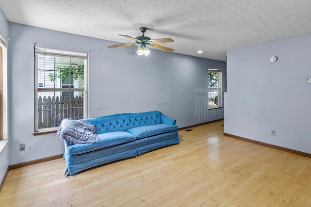 353 Clarendon Ave, Columbus, OH 43223 - living room with wood finished floors, a ceiling fan, baseboards, and a textured ceiling