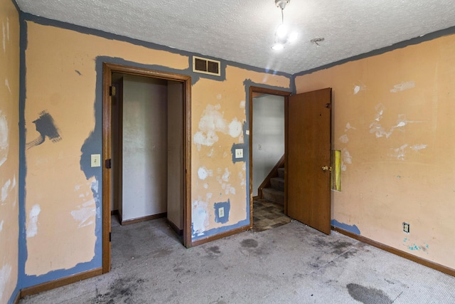 353 Clarendon Ave, Columbus, OH 43223 - empty room with a textured ceiling, carpet flooring, baseboards, and stairway