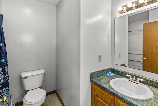 353 Clarendon Ave, Columbus, OH 43223 - bathroom with toilet, vanity, and baseboards