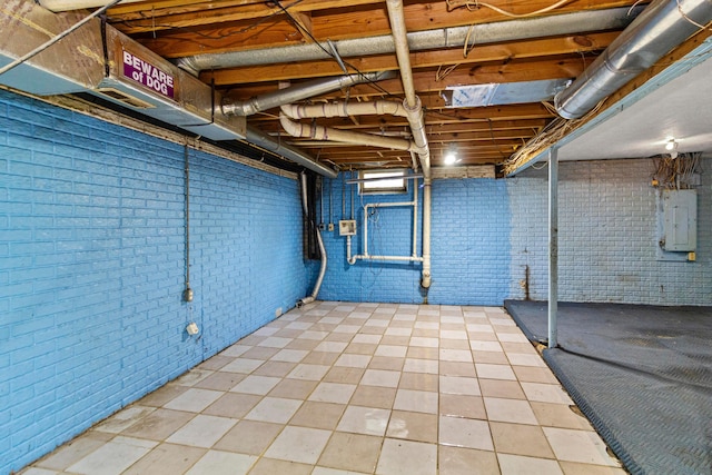 353 Clarendon Ave, Columbus, OH 43223 - unfinished basement featuring electric panel, brick wall, and tile patterned floors