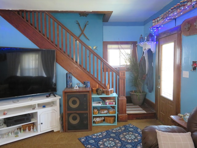 carpeted foyer featuring stairway
