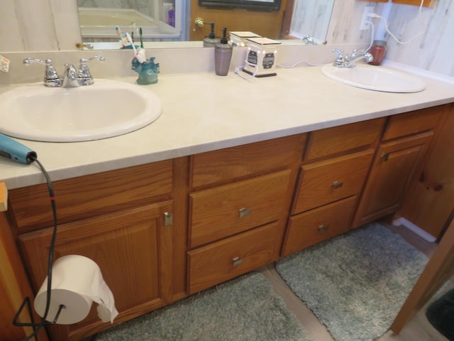 full bathroom featuring double vanity and a sink