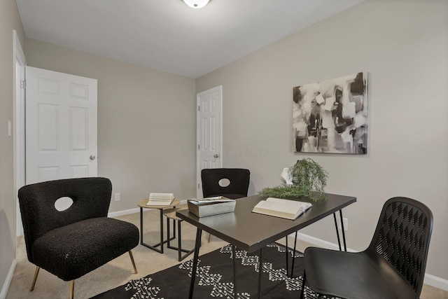 home office with baseboards and light carpet