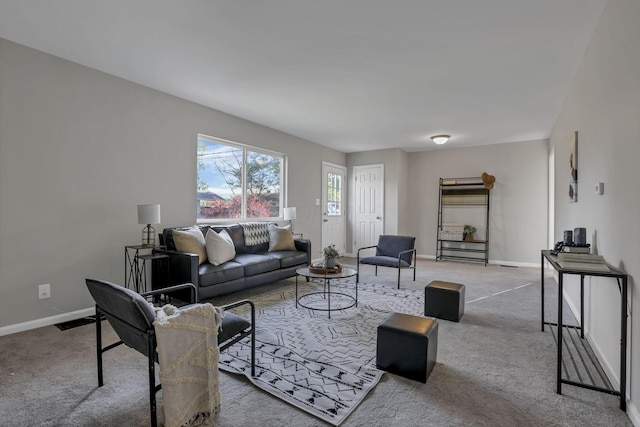living area with baseboards, carpet, and visible vents