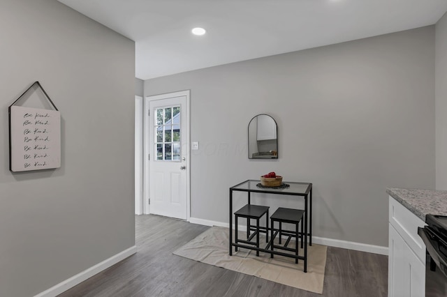 interior space with recessed lighting, baseboards, and wood finished floors