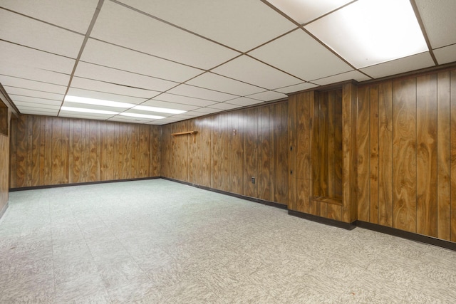 5308 Sharon Ave, Columbus, OH 43214 - finished below grade area with a paneled ceiling, light floors, wood walls, and baseboards