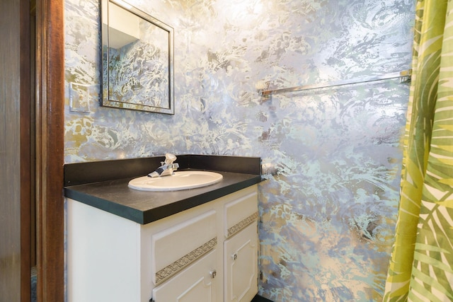 5308 Sharon Ave, Columbus, OH 43214 - bathroom with wallpapered walls and vanity