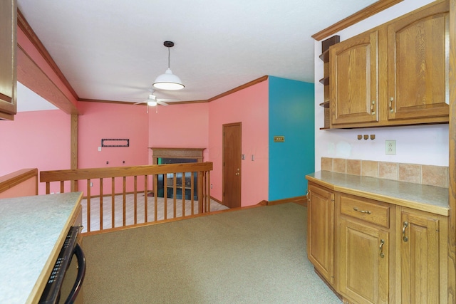 5308 Sharon Ave, Columbus, OH 43214 - kitchen with a ceiling fan, light countertops, light carpet, pendant lighting, and brown cabinets