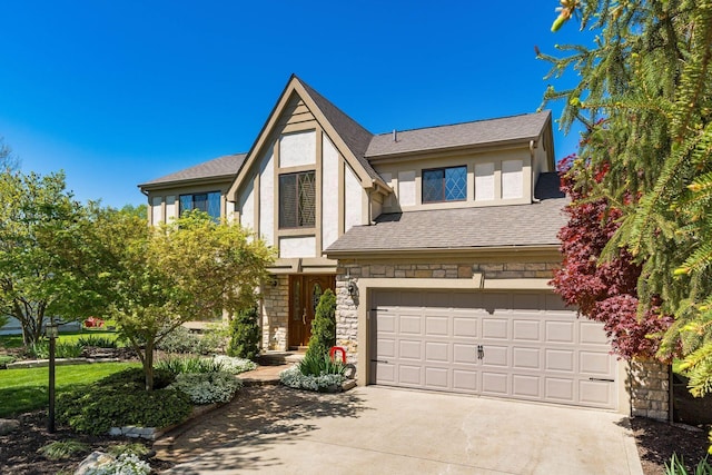12385 Woodsfield Cir E, Pickerington, OH 43147 - tudor-style house featuring a garage, stucco siding, concrete driveway, and stone siding