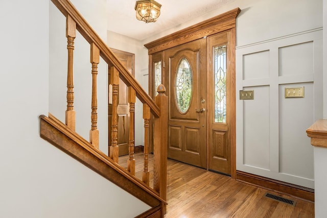 12385 Woodsfield Cir E, Pickerington, OH 43147 - foyer entrance featuring stairway, wood finished floors, and visible vents