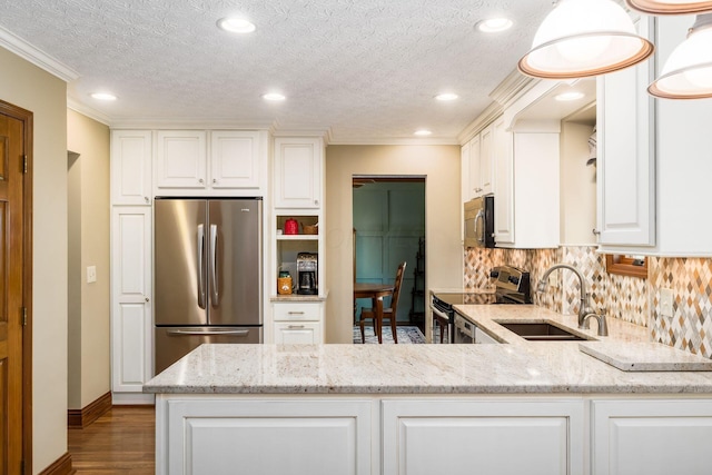 12385 Woodsfield Cir E, Pickerington, OH 43147 - kitchen featuring light stone countertops, appliances with stainless steel finishes, a sink, white cabinetry, and wood finished floors