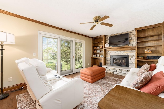12385 Woodsfield Cir E, Pickerington, OH 43147 - living room with a fireplace, a ceiling fan, baseboards, wood finished floors, and ornamental molding