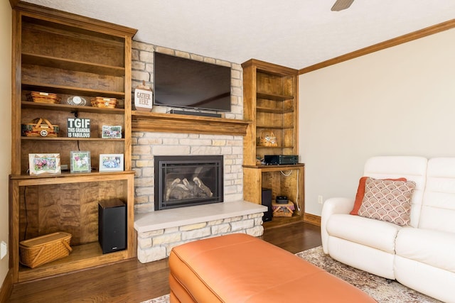 12385 Woodsfield Cir E, Pickerington, OH 43147 - living room with a stone fireplace, built in features, baseboards, ornamental molding, and dark wood-type flooring