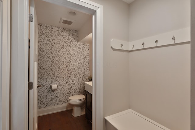 1012 Ewing Aly, Columbus, OH 43201 - bathroom featuring baseboards, vanity, wallpapered walls, and wood finished floors