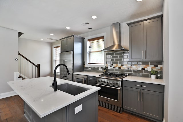 1012 Ewing Aly, Columbus, OH 43201 - kitchen featuring high quality appliances, a sink, wall chimney exhaust hood, tasteful backsplash, and visible vents