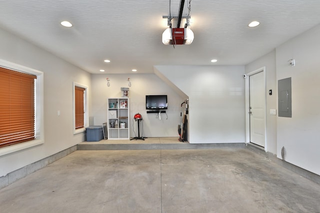 1012 Ewing Aly, Columbus, OH 43201 - garage featuring a garage door opener, electric panel, and recessed lighting