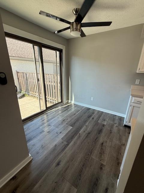 302 Saint Andrews Dr Unit 302, Dublin, OH 43017 - unfurnished dining area with ceiling fan, dark wood-style flooring, and a textured ceiling
