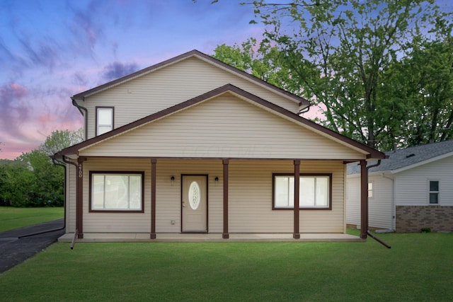 view of front facade featuring a porch and a lawn