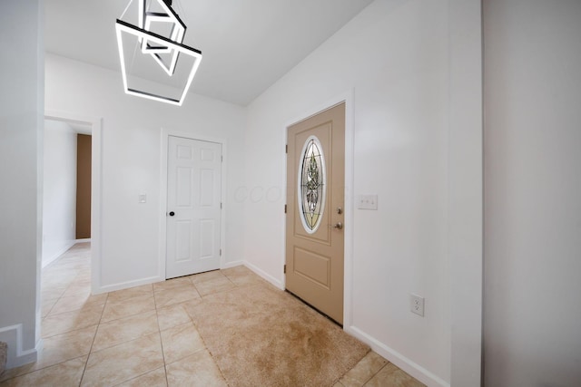 foyer featuring light tile patterned flooring and baseboards