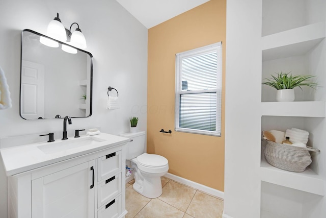 bathroom featuring toilet, baseboards, tile patterned flooring, and vanity