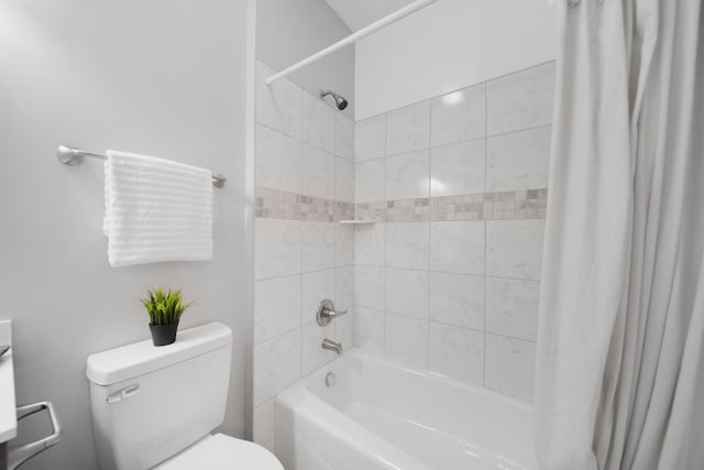 bathroom featuring shower / bath combination with curtain and toilet