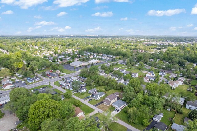 aerial view of property and surrounding area featuring nearby suburban area