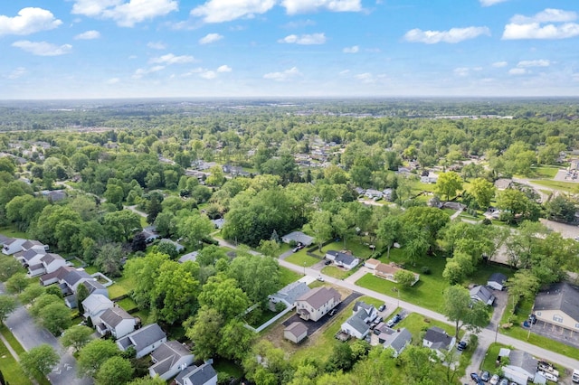 aerial view of residential area featuring a forest