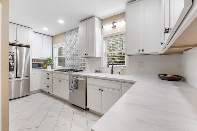 kitchen with recessed lighting, a sink, appliances with stainless steel finishes, and light countertops