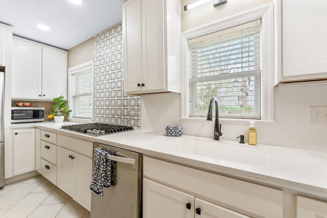 kitchen featuring stainless steel appliances, recessed lighting, a wealth of natural light, and a sink