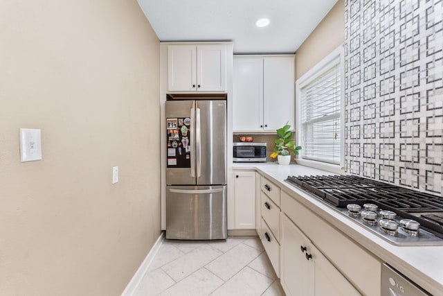 kitchen featuring light countertops, white cabinets, and stainless steel appliances
