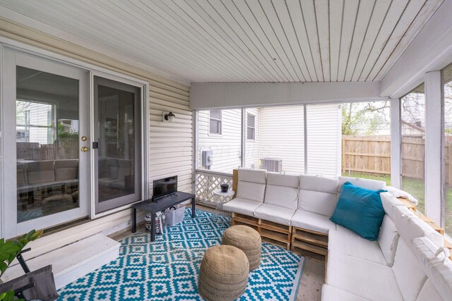 sunroom / solarium featuring outdoor lounge area