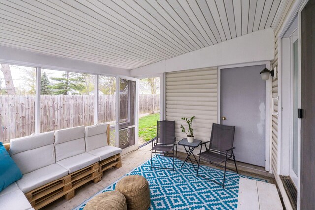 sunroom featuring an outdoor hangout area