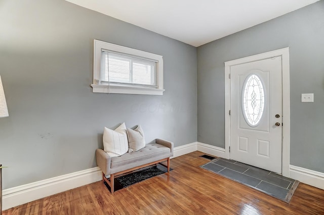 entrance foyer with visible vents, baseboards, and wood finished floors