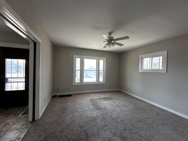 406 W Church St, Newark, OH 43055 - carpeted spare room with baseboards, a ceiling fan, and visible vents