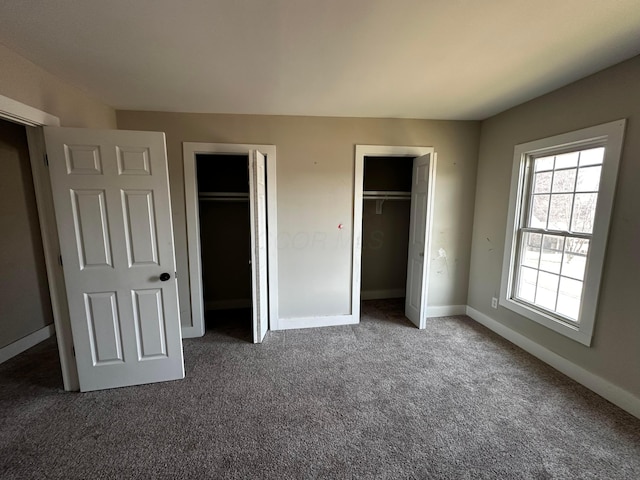 406 W Church St, Newark, OH 43055 - unfurnished bedroom with multiple closets, baseboards, and carpet