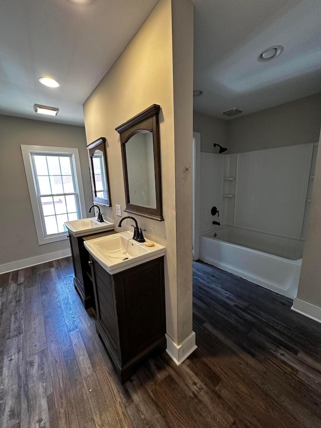 406 W Church St, Newark, OH 43055 - bathroom with baseboards, a sink, wood finished floors, and bathtub / shower combination